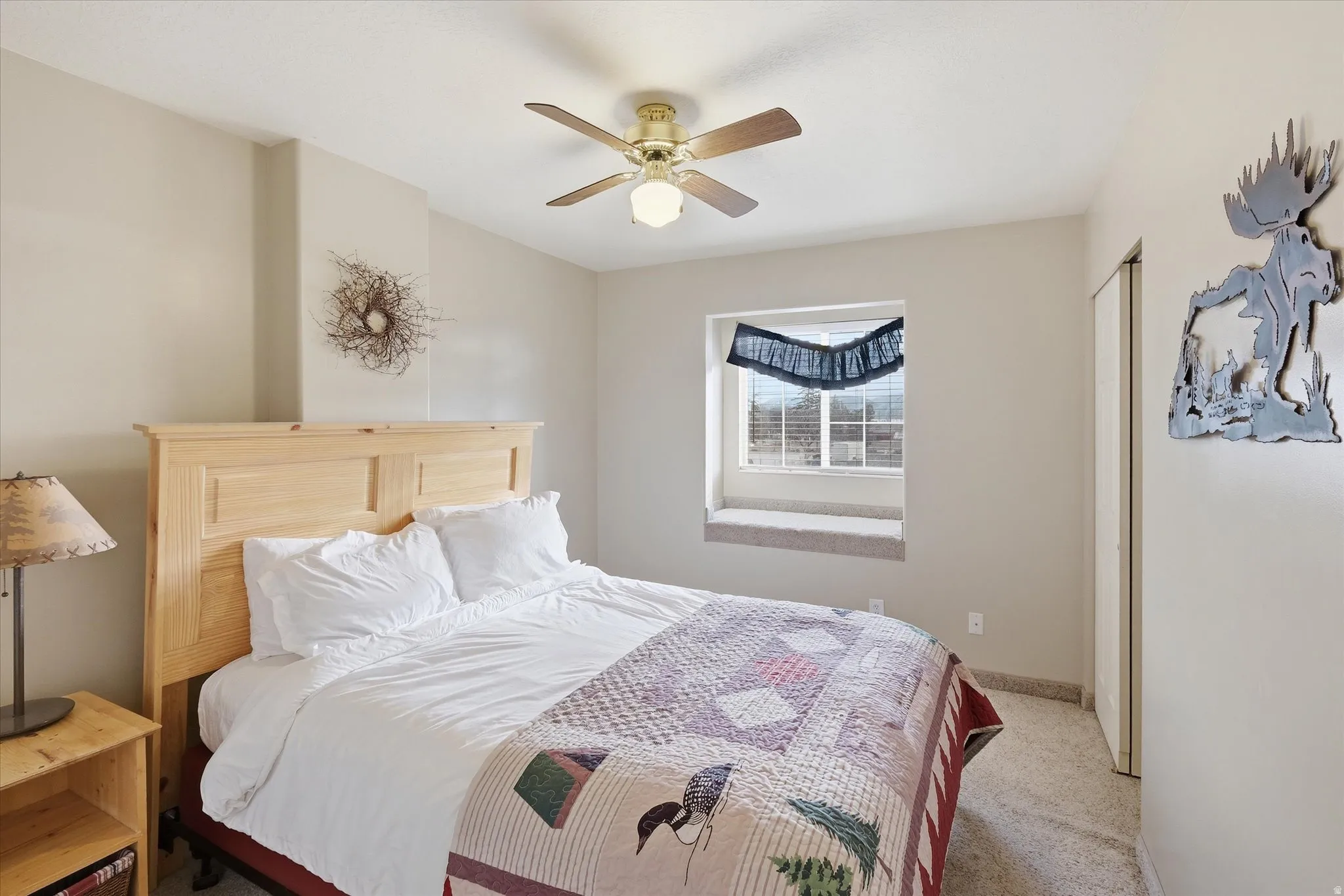 Bedroom featuring light carpet and ceiling fan