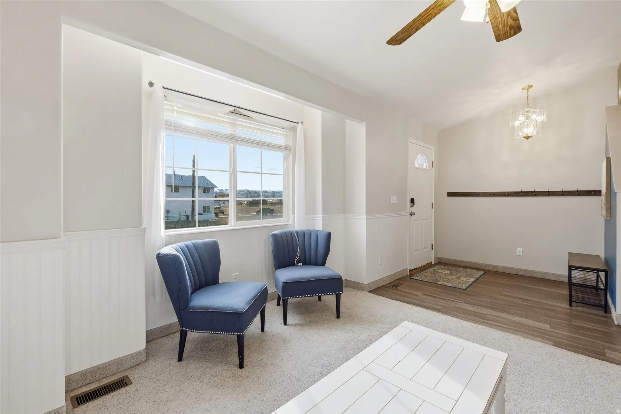 Sitting room featuring ceiling fan and hanging lights