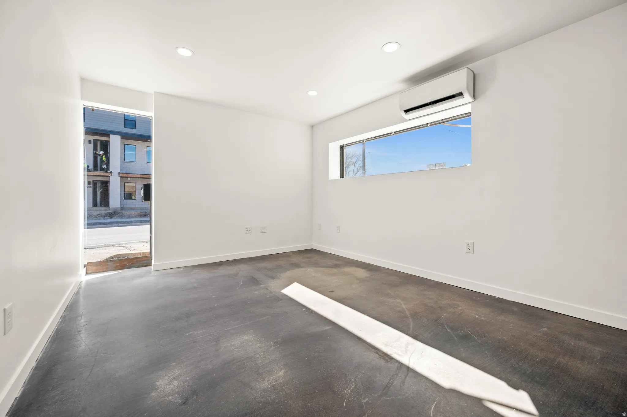 Unfurnished room featuring concrete floors and recessed lighting