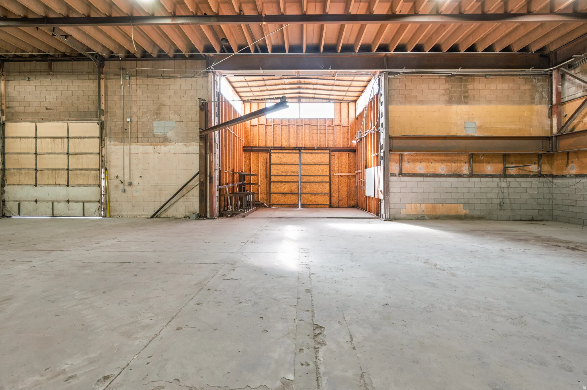 Garage featuring concrete block wall