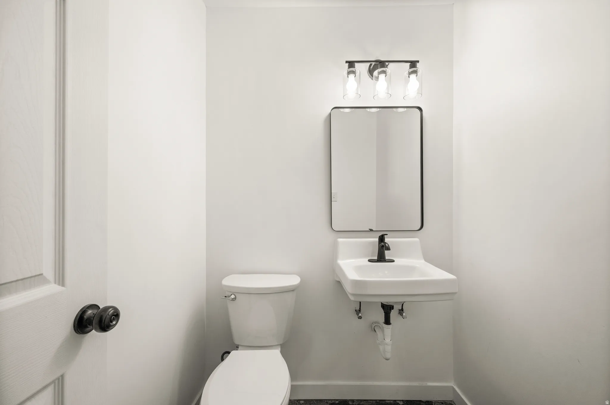 Bathroom with toilet and baseboards
