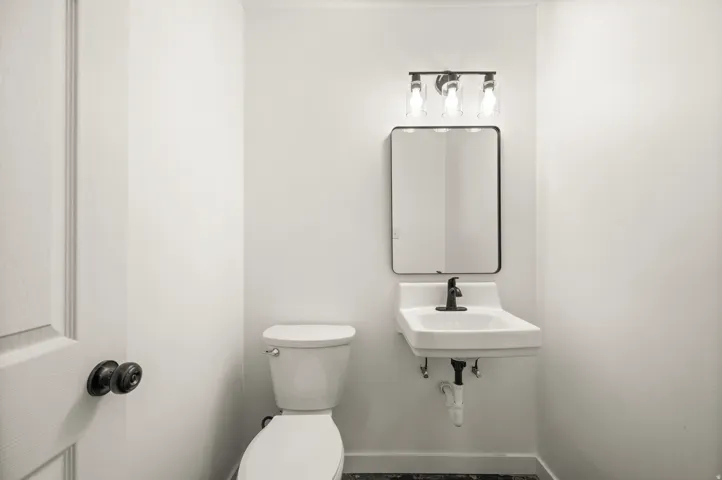 Bathroom with toilet and baseboards