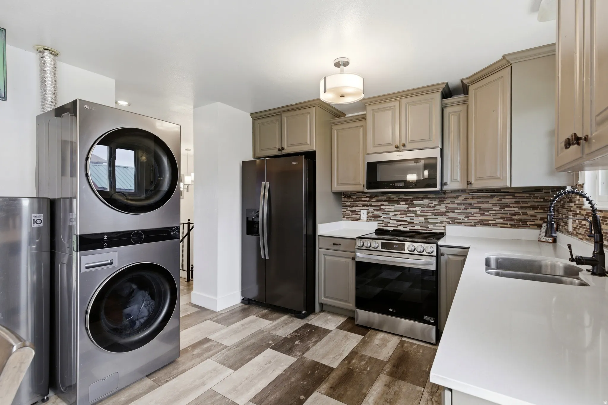 Updated Kitchen with stainless steel appliances & stacked washer and dryer included.