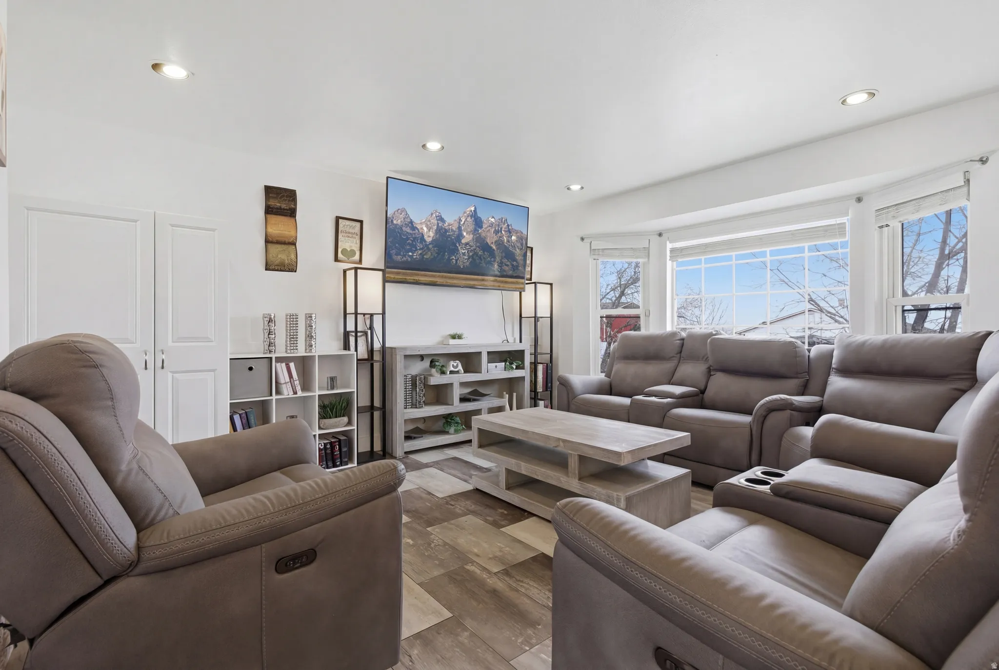 Updated bright living room with can lights and lots of natural light.