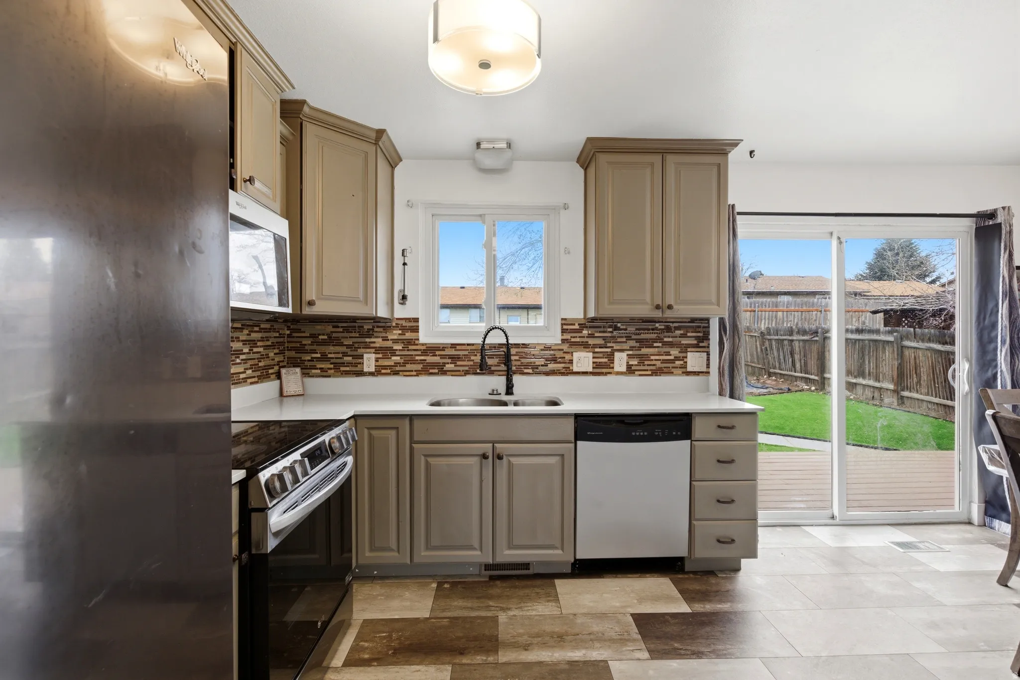Updated Kitchen featuring stainless steel appliances and quartz countertops