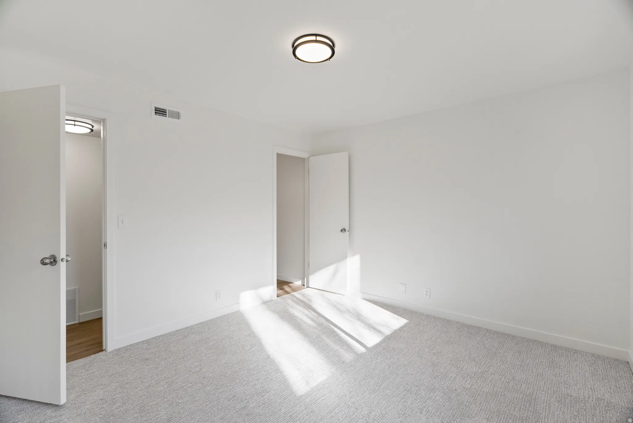 Bedroom showing door to hallway and door to bathroom