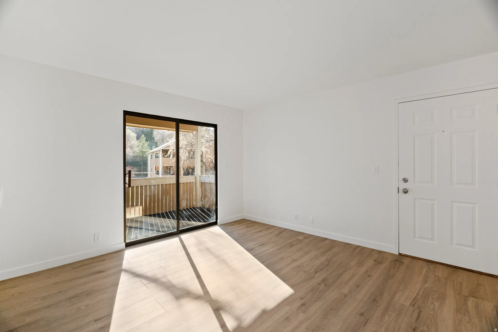Living room showing sliding glass door to balcony
