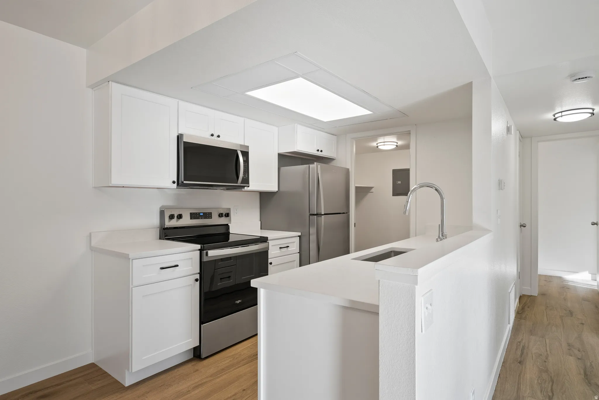 Kitchen featuring new cabinets, countertops, and brand new stainless steel appliances