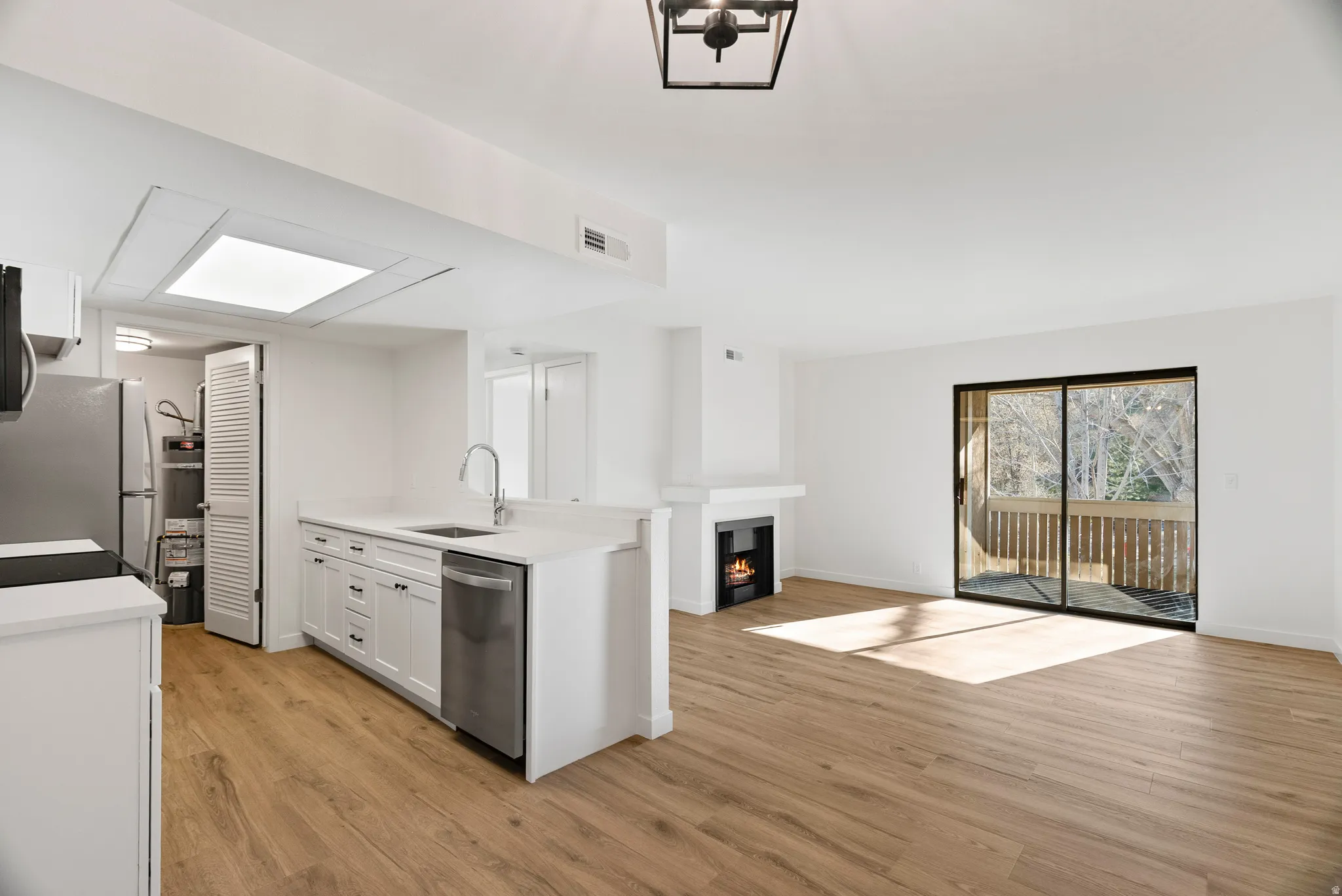 View from dining area showing the living room area and sliding glass door to balcony