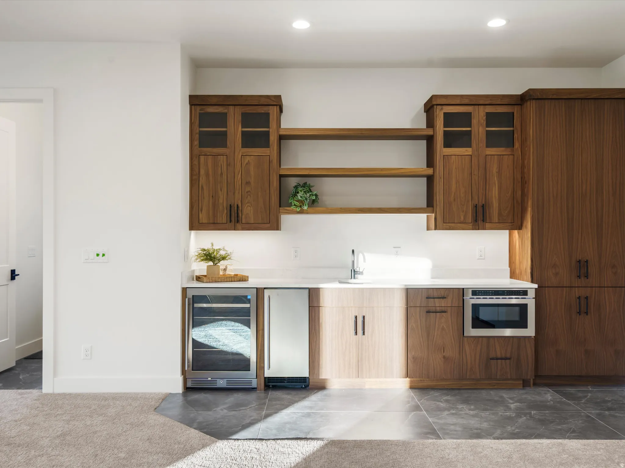 Kitchen featuring glass insert cabinets, beverage cooler, recessed lighting, open shelves, and stainless steel oven