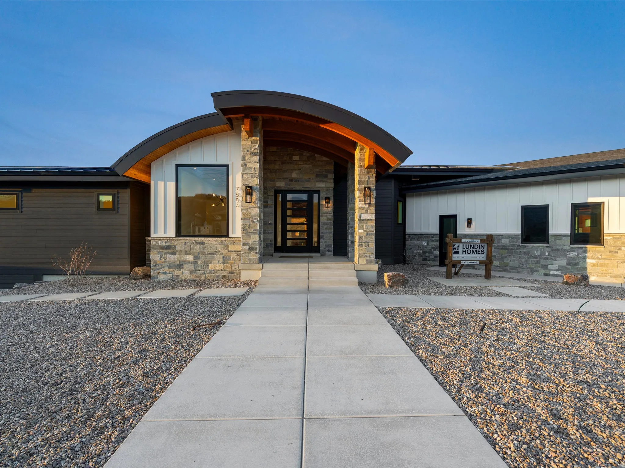 Entrance to property with stone siding and board and batten siding