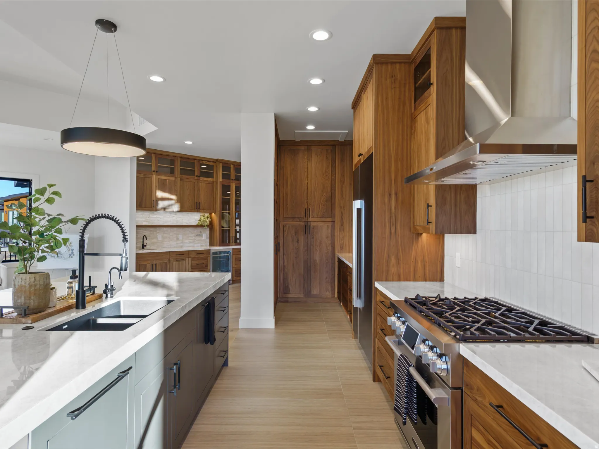 Kitchen with tasteful backsplash, stainless steel appliances, and light stone countertops