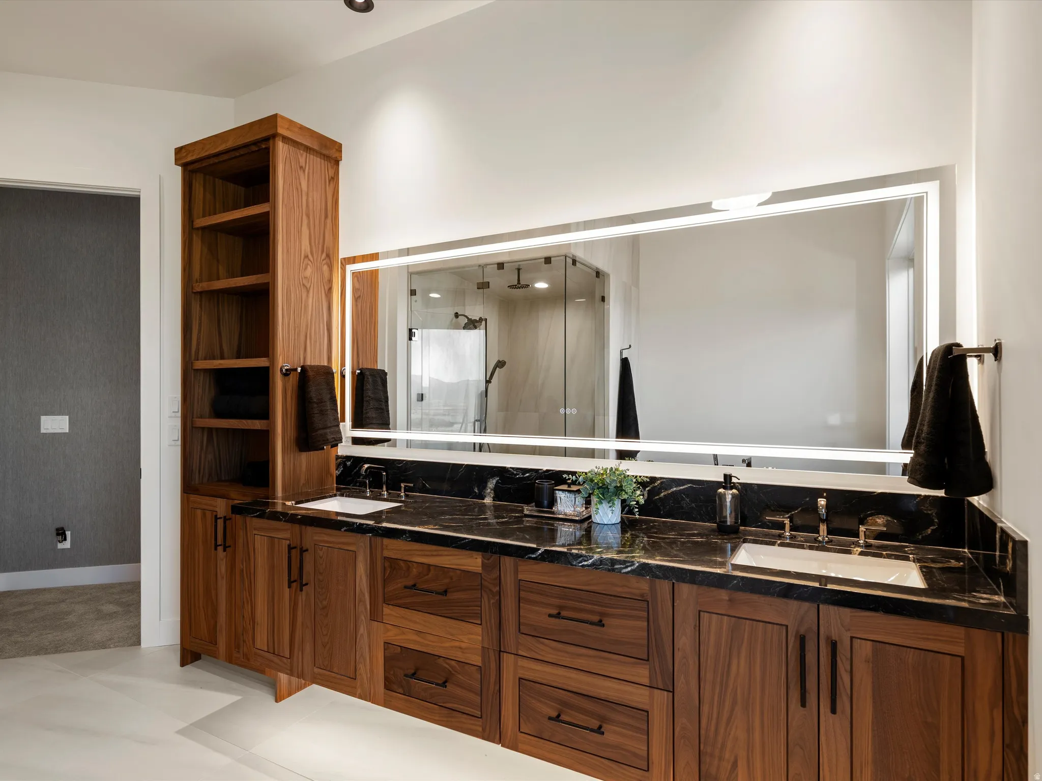Bathroom with double vanity and a stall shower