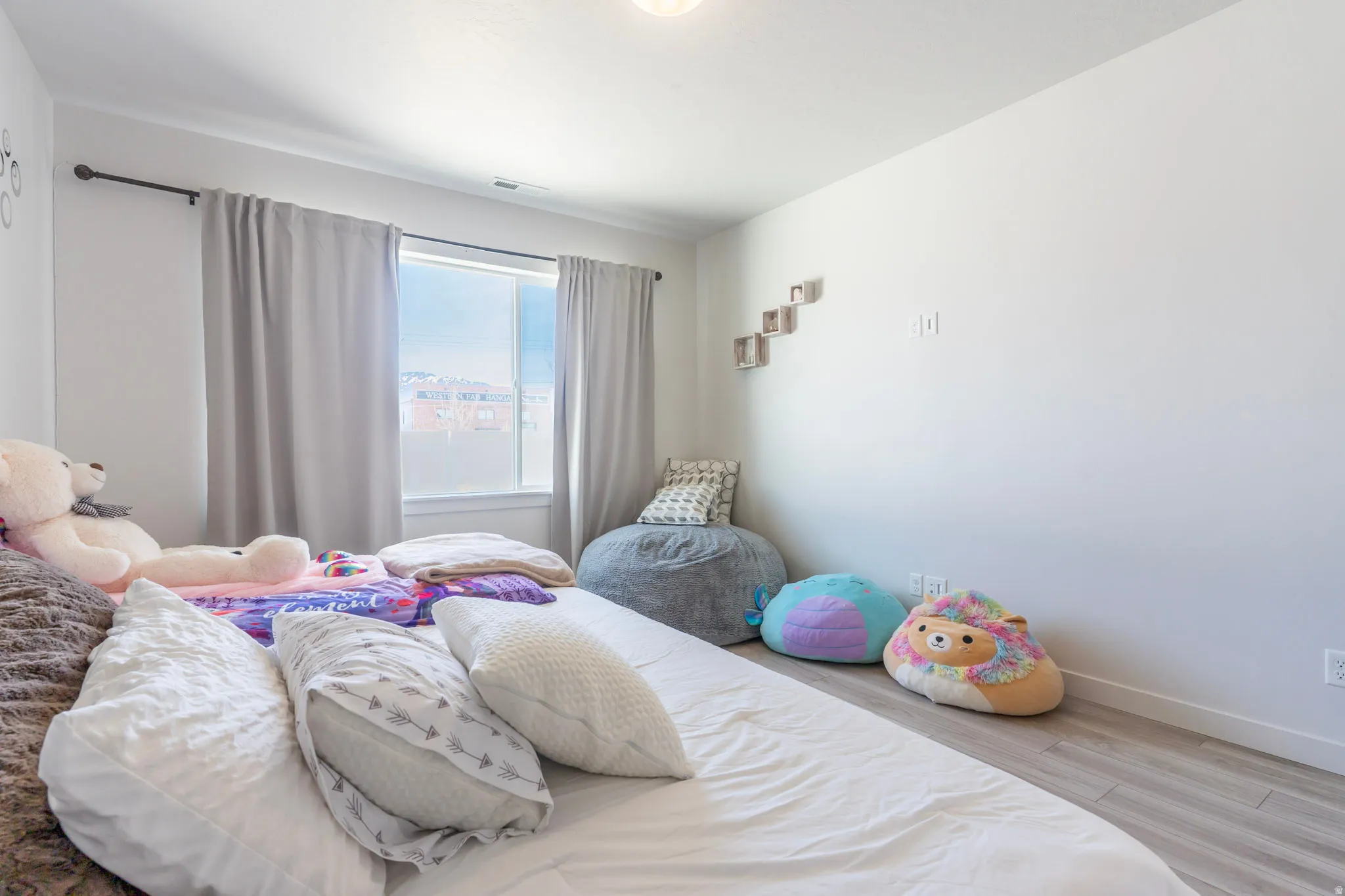 Bedroom with light wood finished floors and baseboards