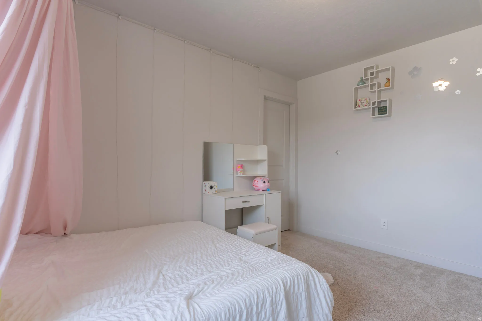 Bedroom with light colored carpet and baseboards