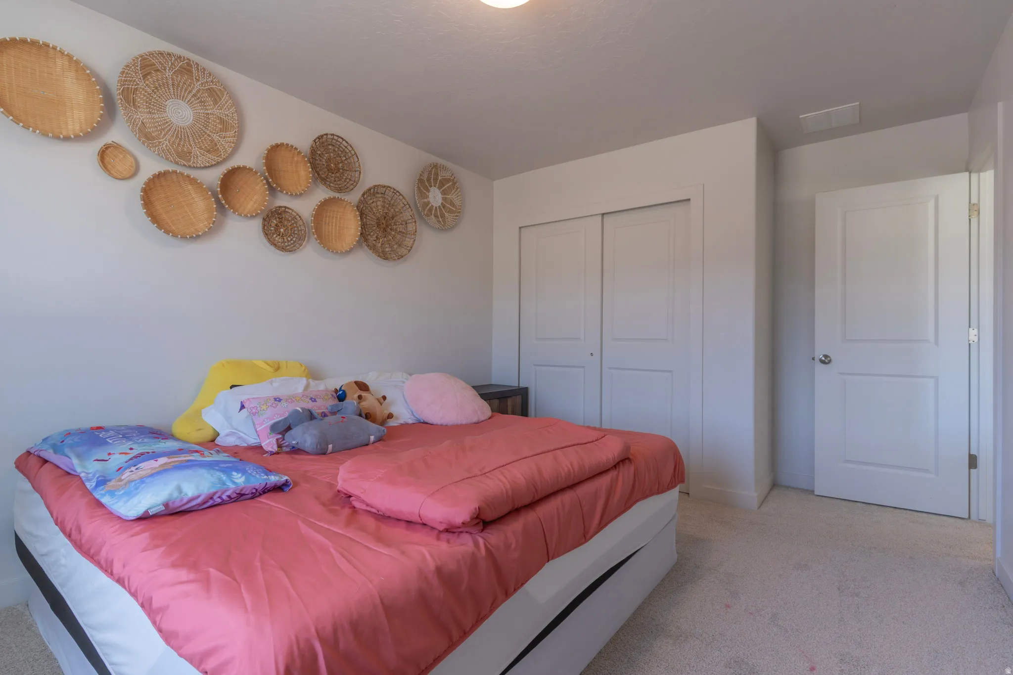Bedroom with carpet and a closet