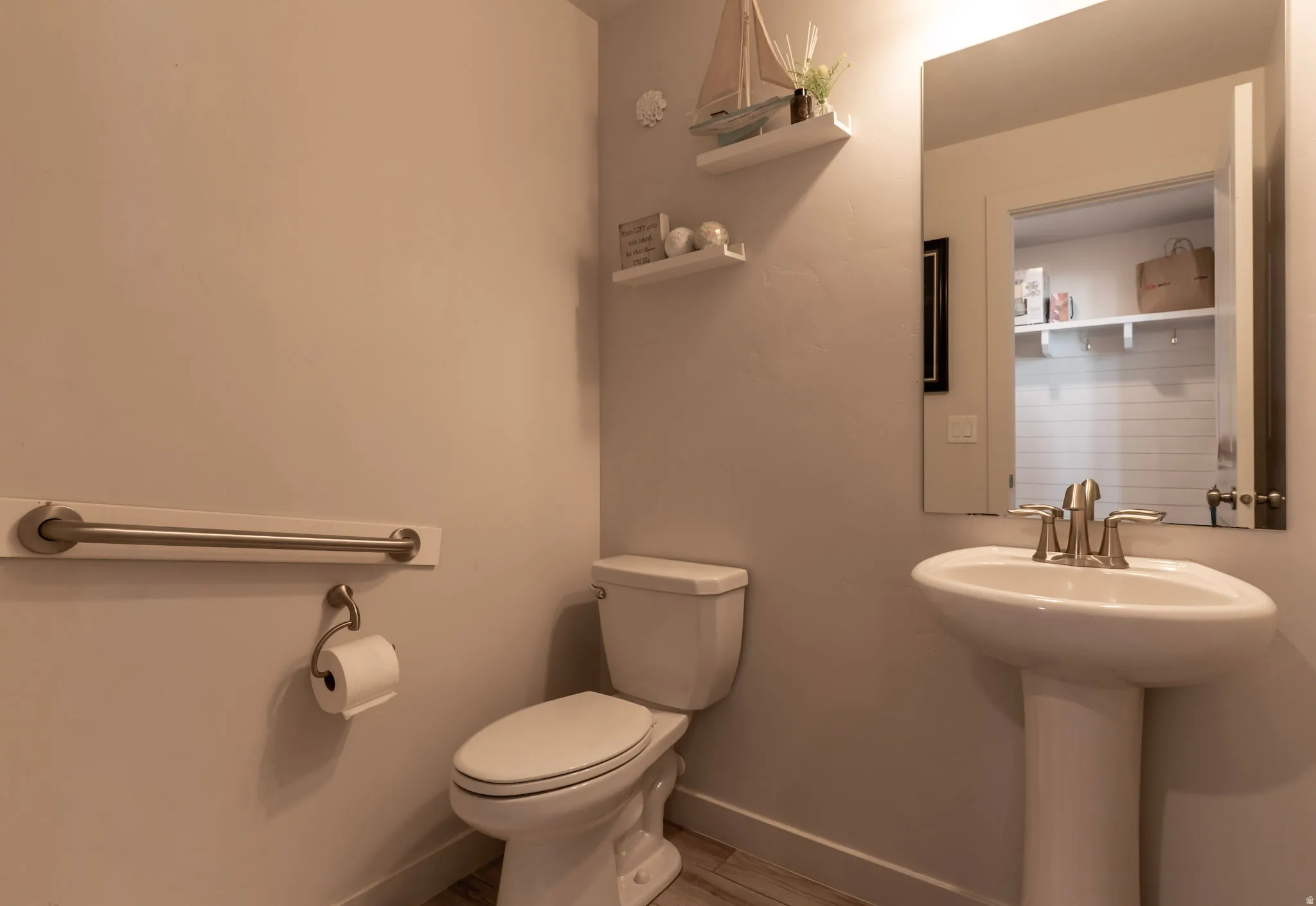 Bathroom with baseboards and light wood-style flooring
