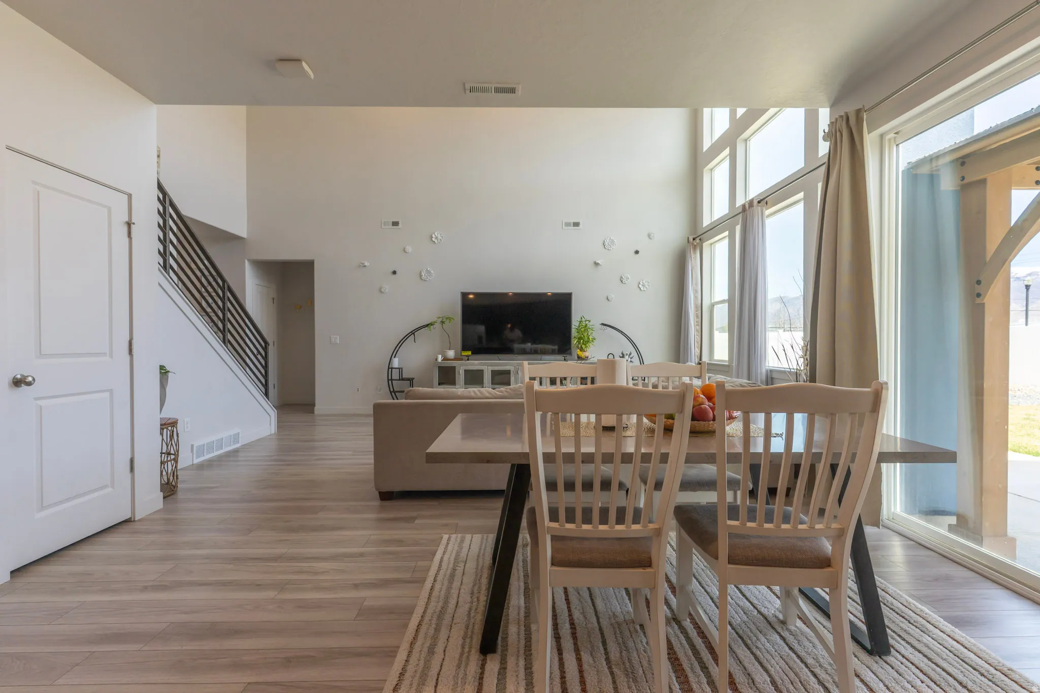 Dining area featuring light wood-type flooring and a high ceiling