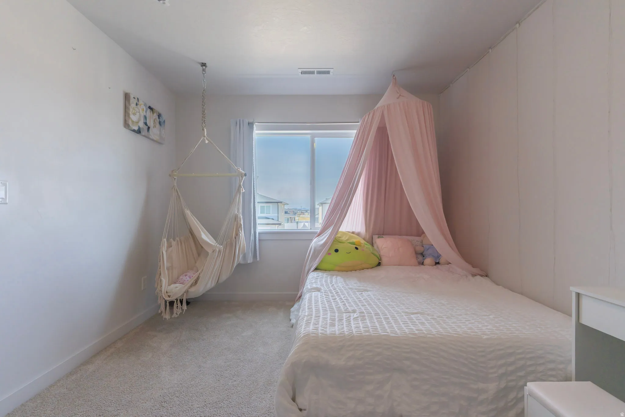 Bedroom with light carpet and baseboards