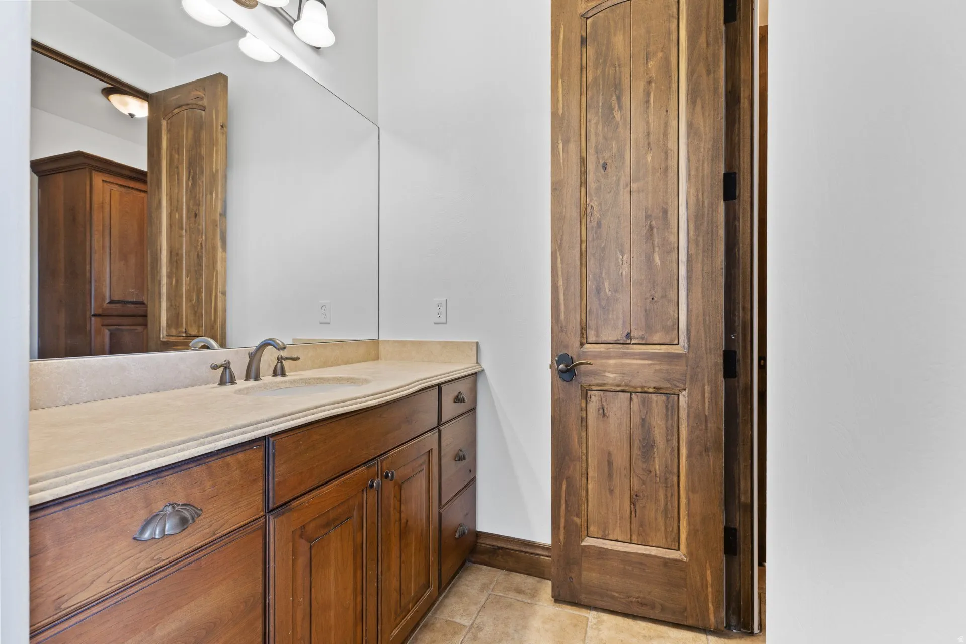 Bathroom featuring vanity and light tile patterned floors