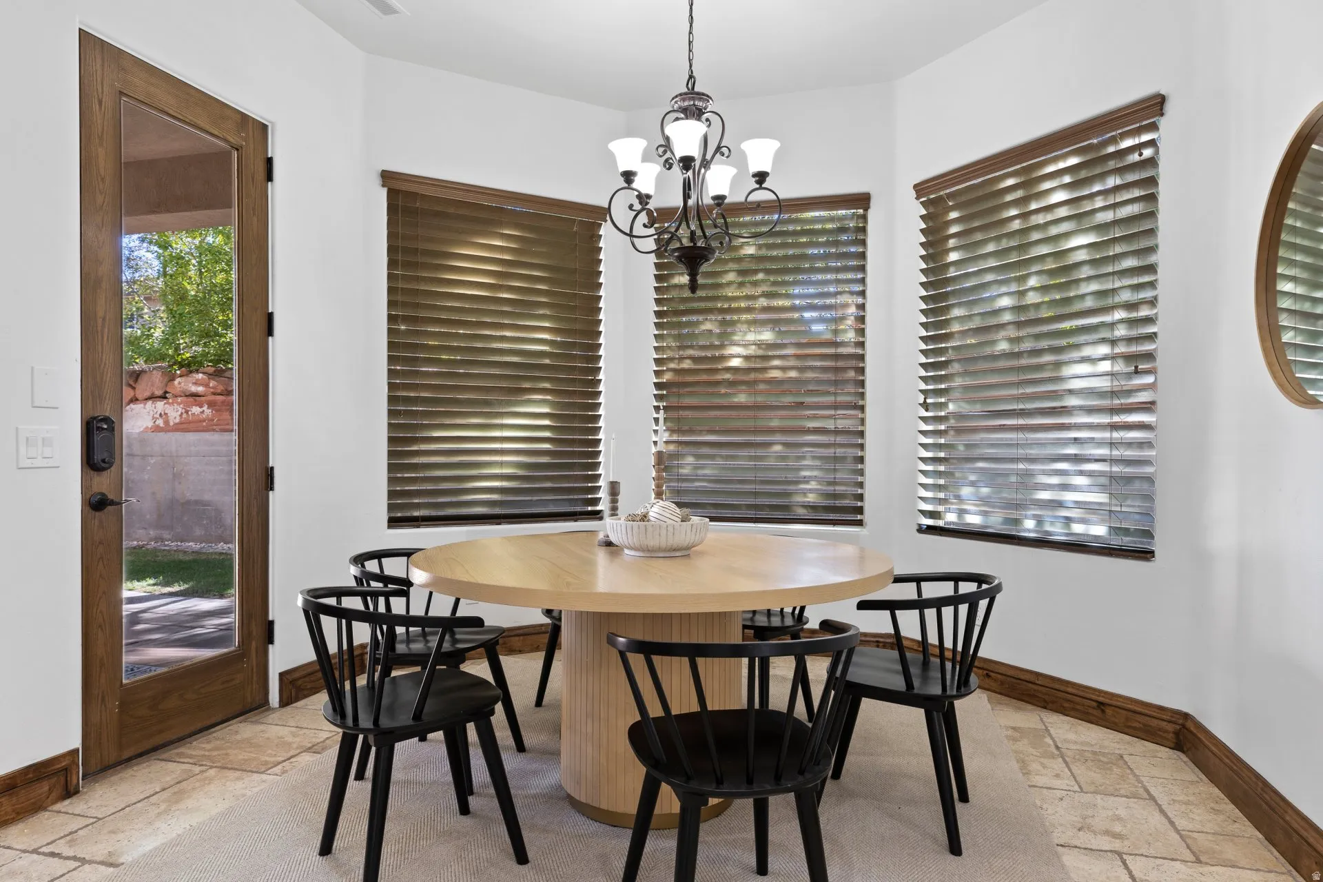 Dining space featuring stone tile flooring and hanging lights