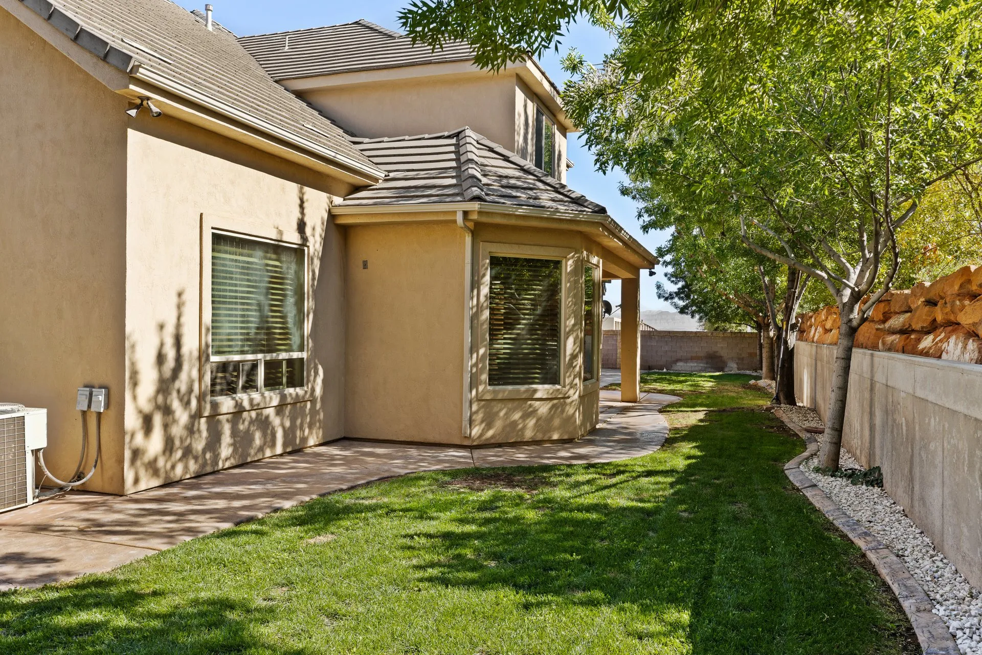 View of home's exterior with a fenced backyard and stucco siding