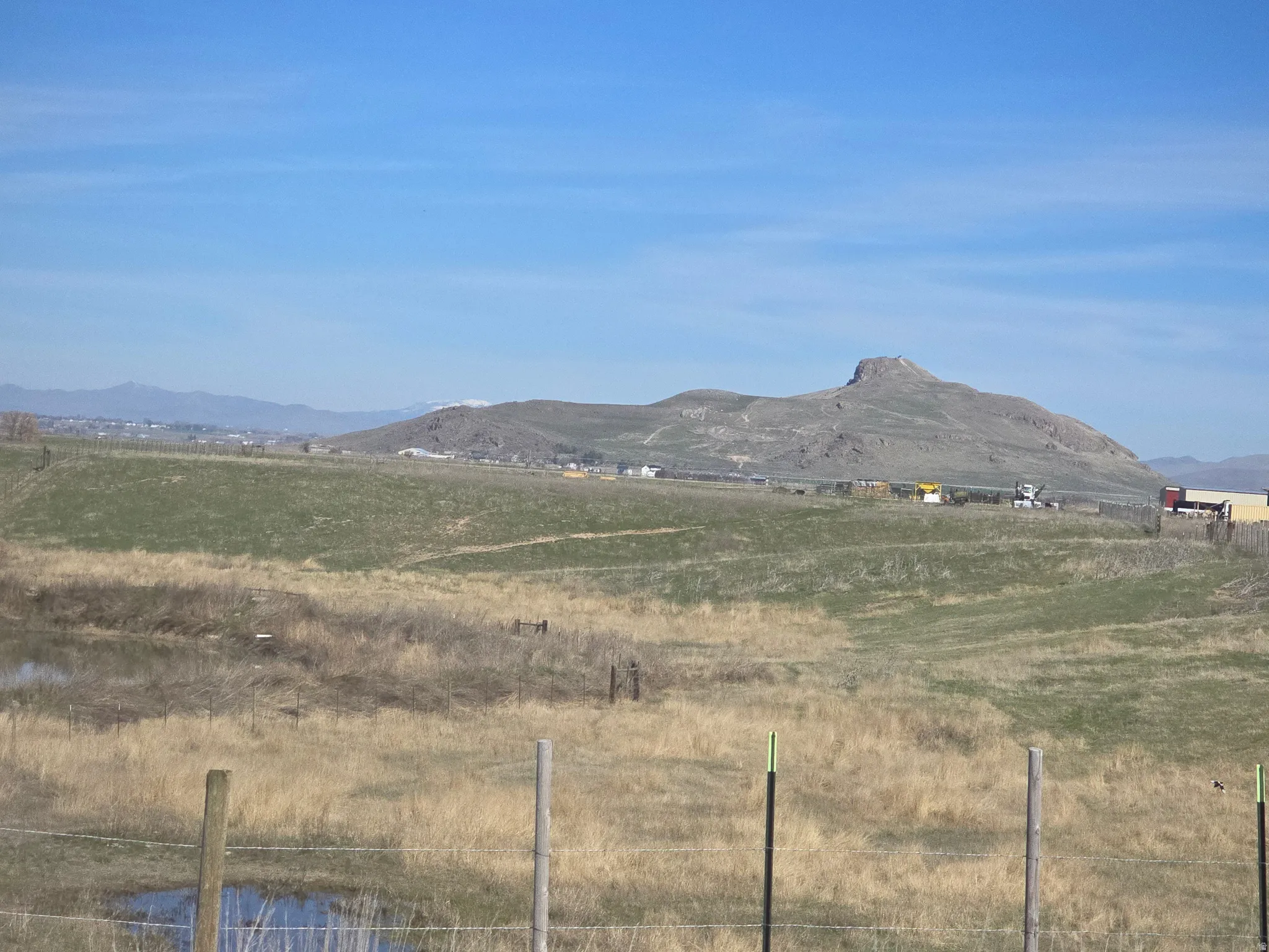 View of mountain backdrop with rural landscape