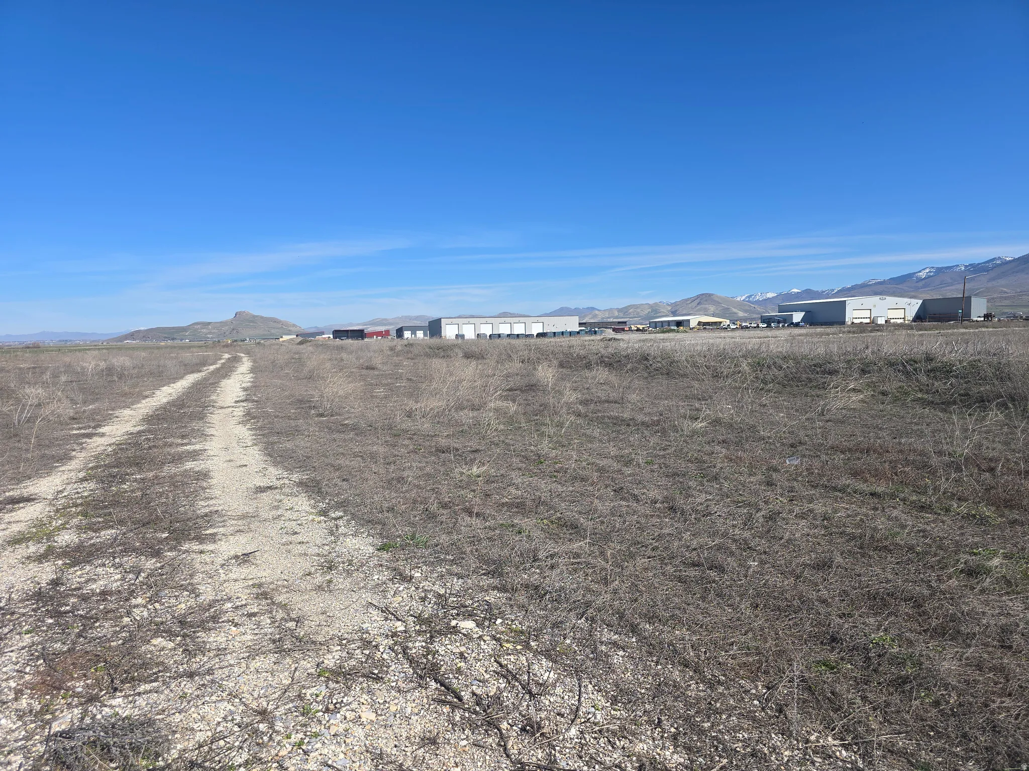 View of dirt / gravel road featuring a mountain view