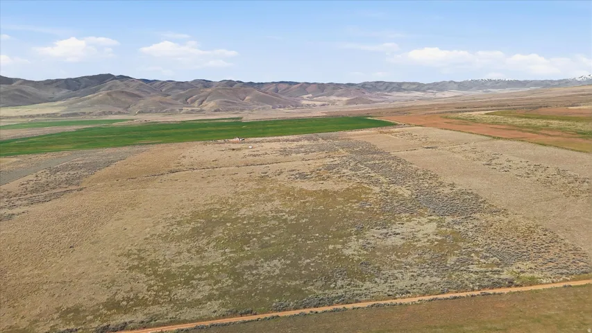 View of mountain backdrop with rural landscape and a desert landscape