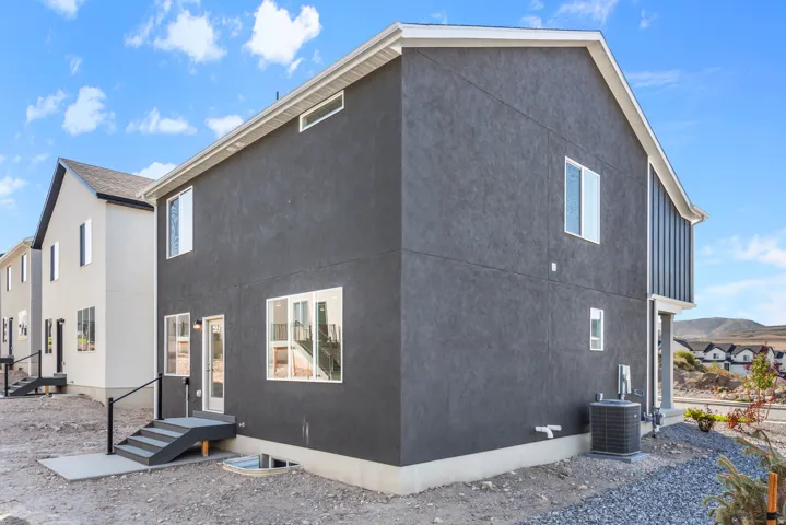 Rear view of house featuring stucco siding