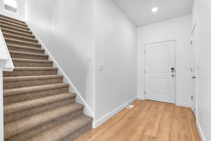 Foyer with light wood-type flooring and recessed lighting