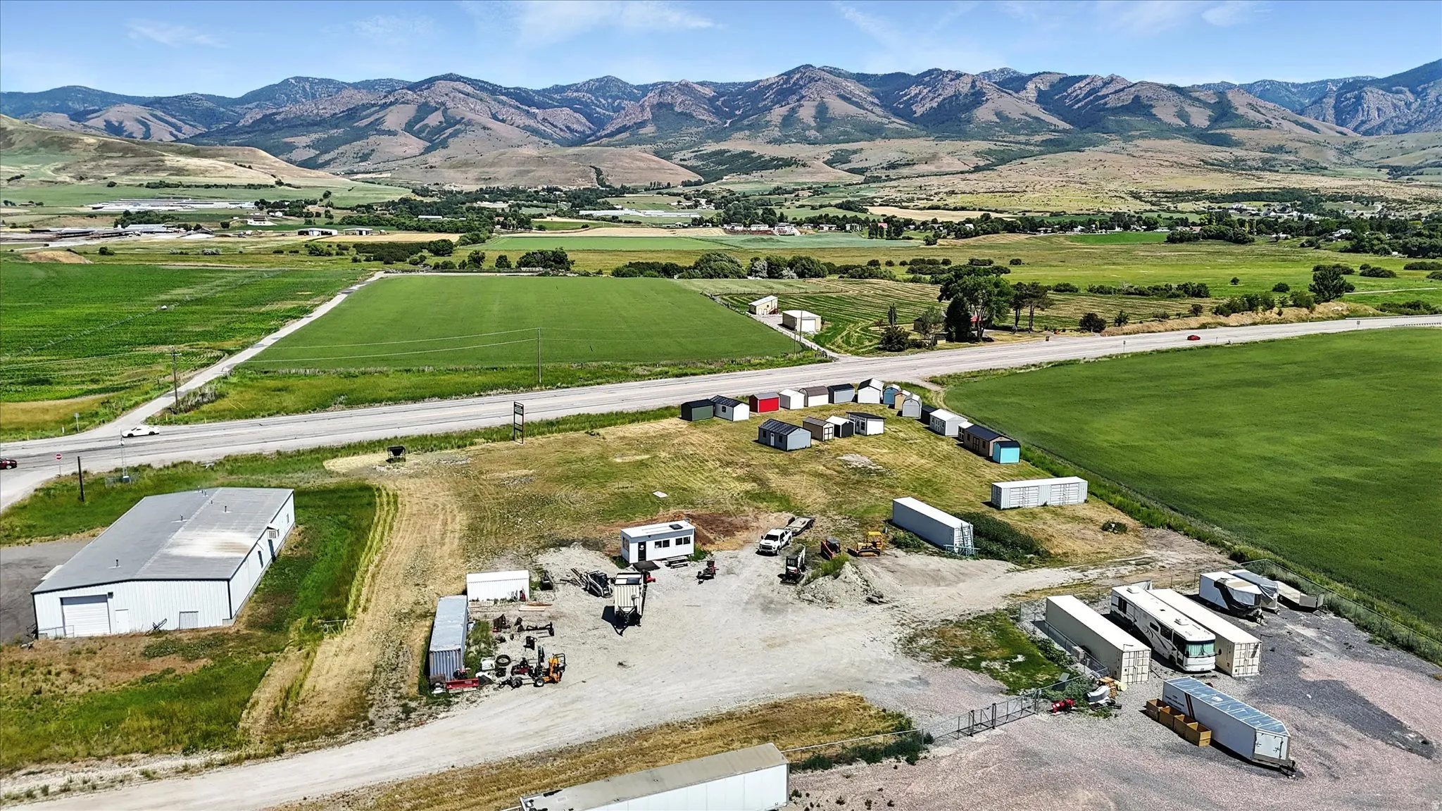 Aerial view of property and surrounding area with mountains and rural landscape