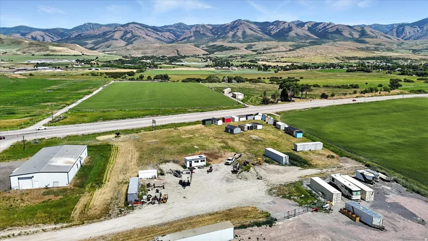 Aerial view of property and surrounding area with mountains and rural landscape
