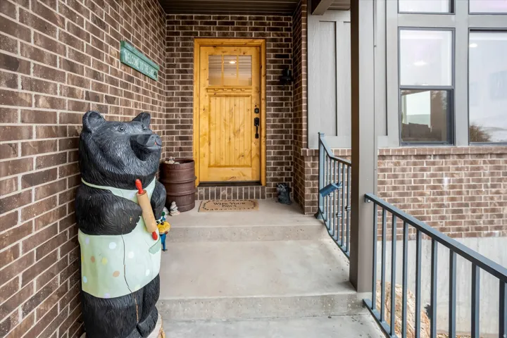 Property entrance with brick siding and covered porch