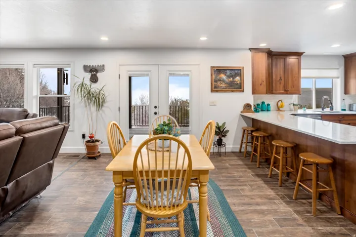 Dining area featuring french doors, dark wood-style flooring, and recessed lighting