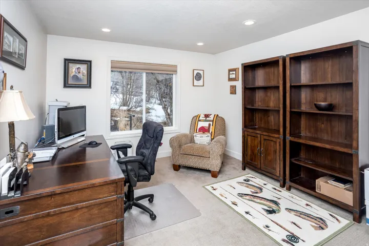 Office area with light colored carpet and recessed lighting