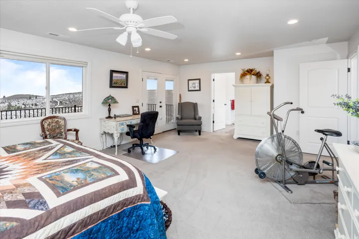 Bedroom featuring access to exterior, light carpet, multiple windows, a ceiling fan, and recessed lighting