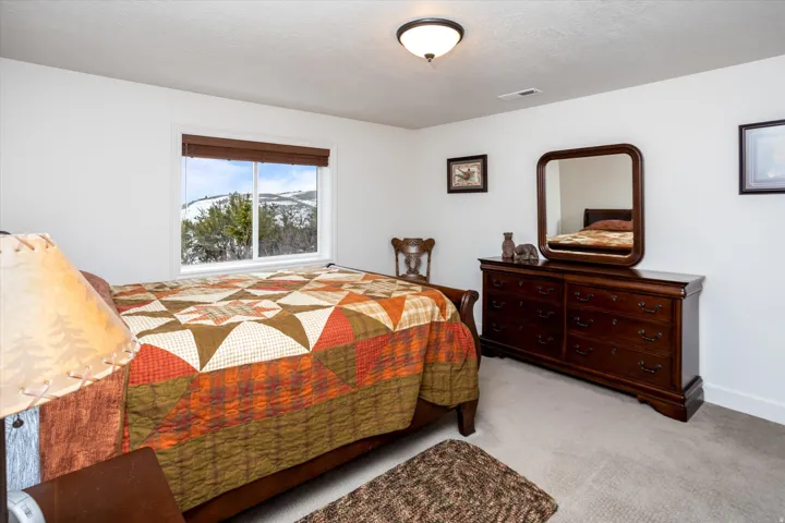 Bedroom with light colored carpet