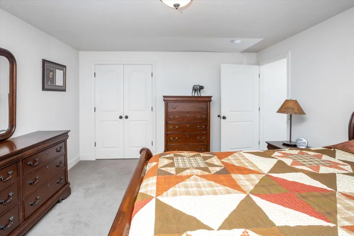 Carpeted bedroom featuring a closet and baseboards