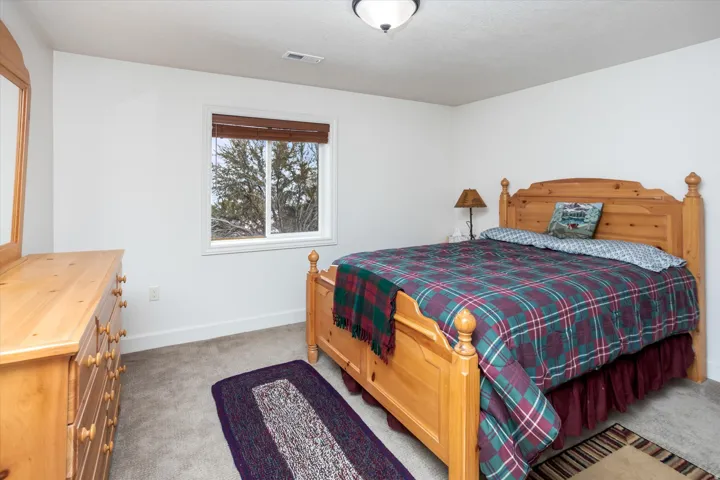 Bedroom featuring light colored carpet