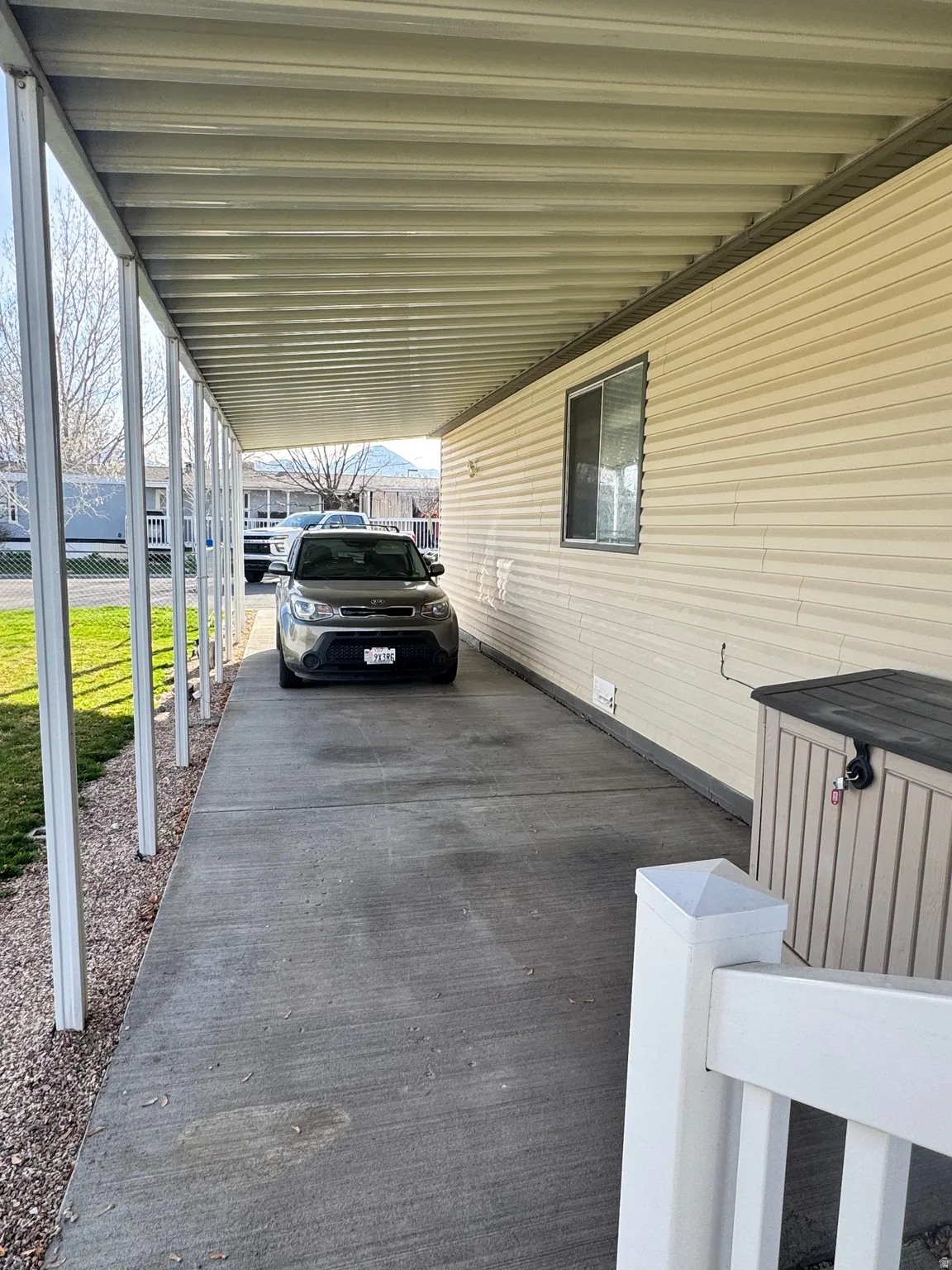 View of parking featuring a carport