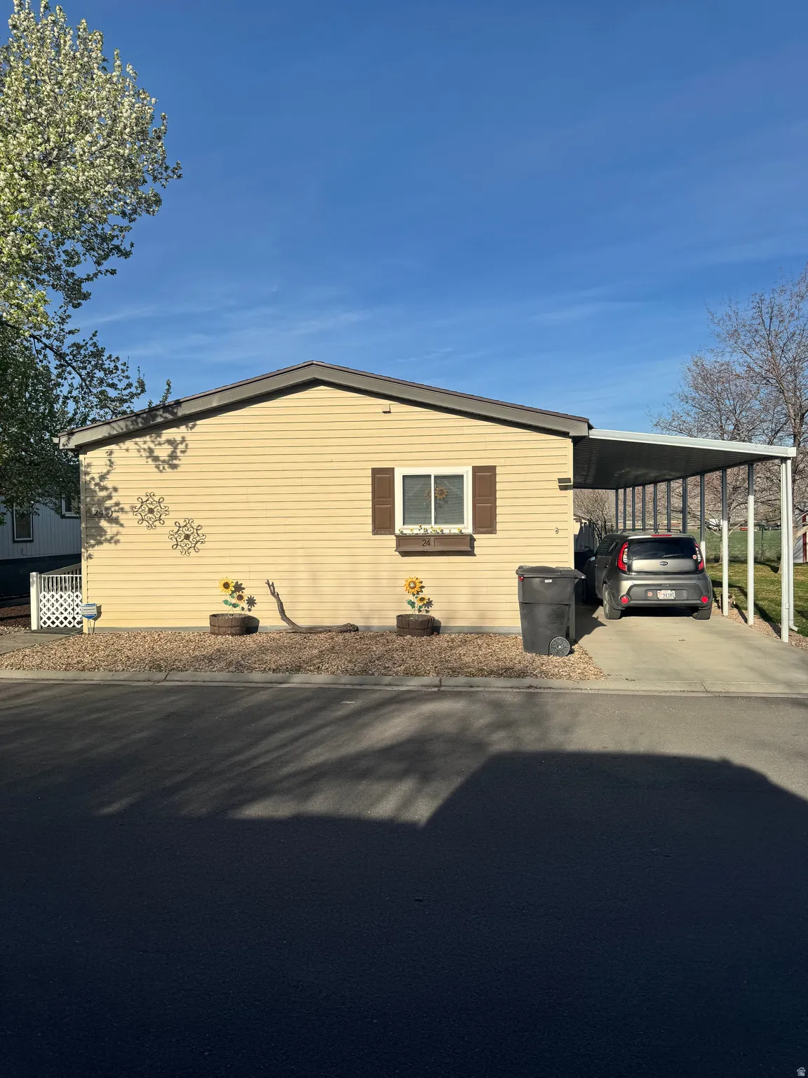 View of side of property featuring a carport and driveway