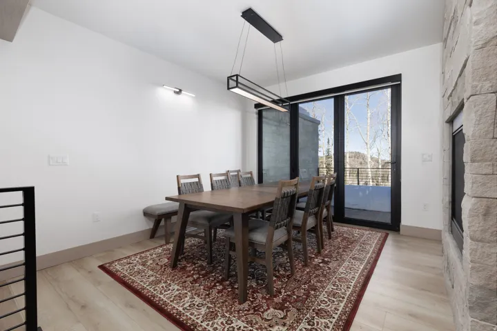 Dining space featuring light wood finished floors and a fireplace