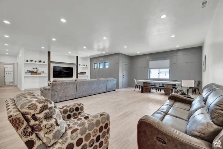 Living area featuring light wood-type flooring and recessed lighting