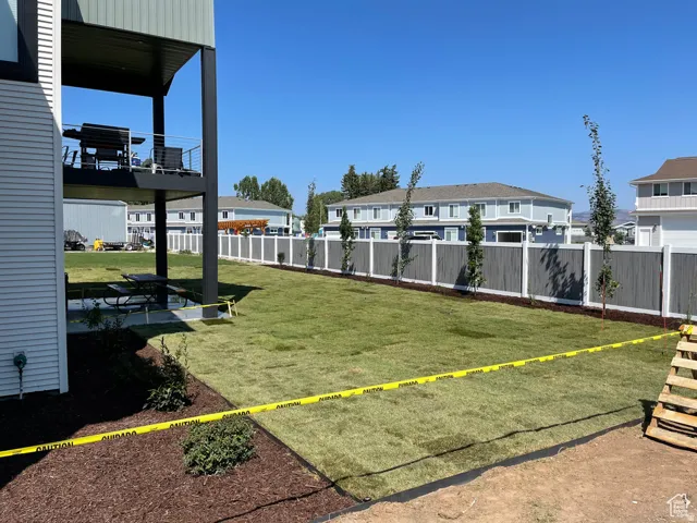 Fenced backyard featuring a patio and a residential view