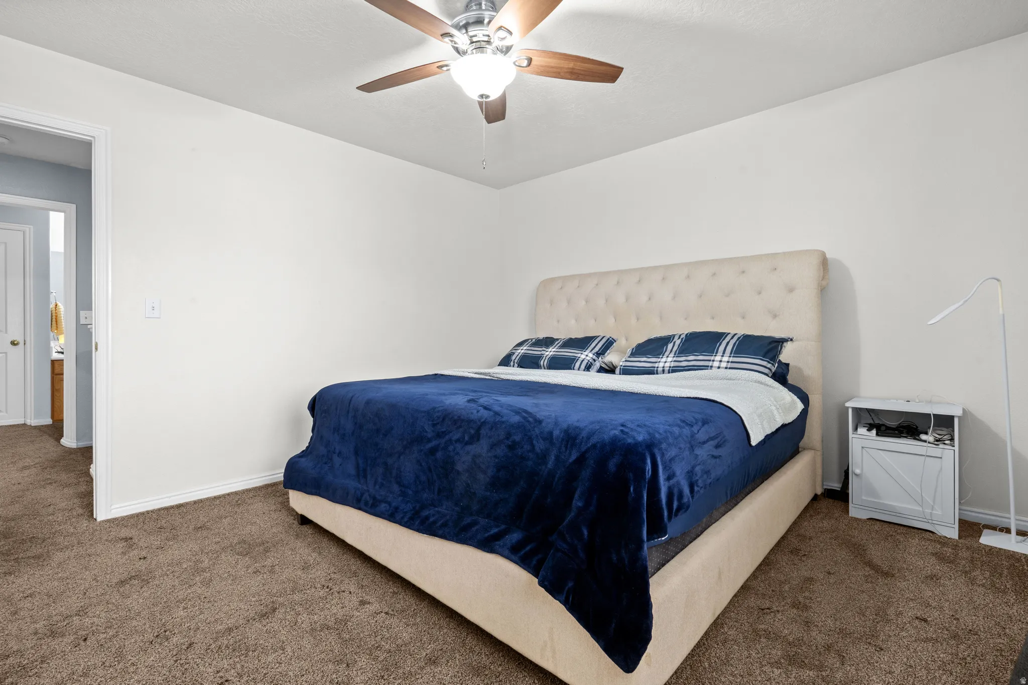 Bedroom with carpet flooring and a ceiling fan
