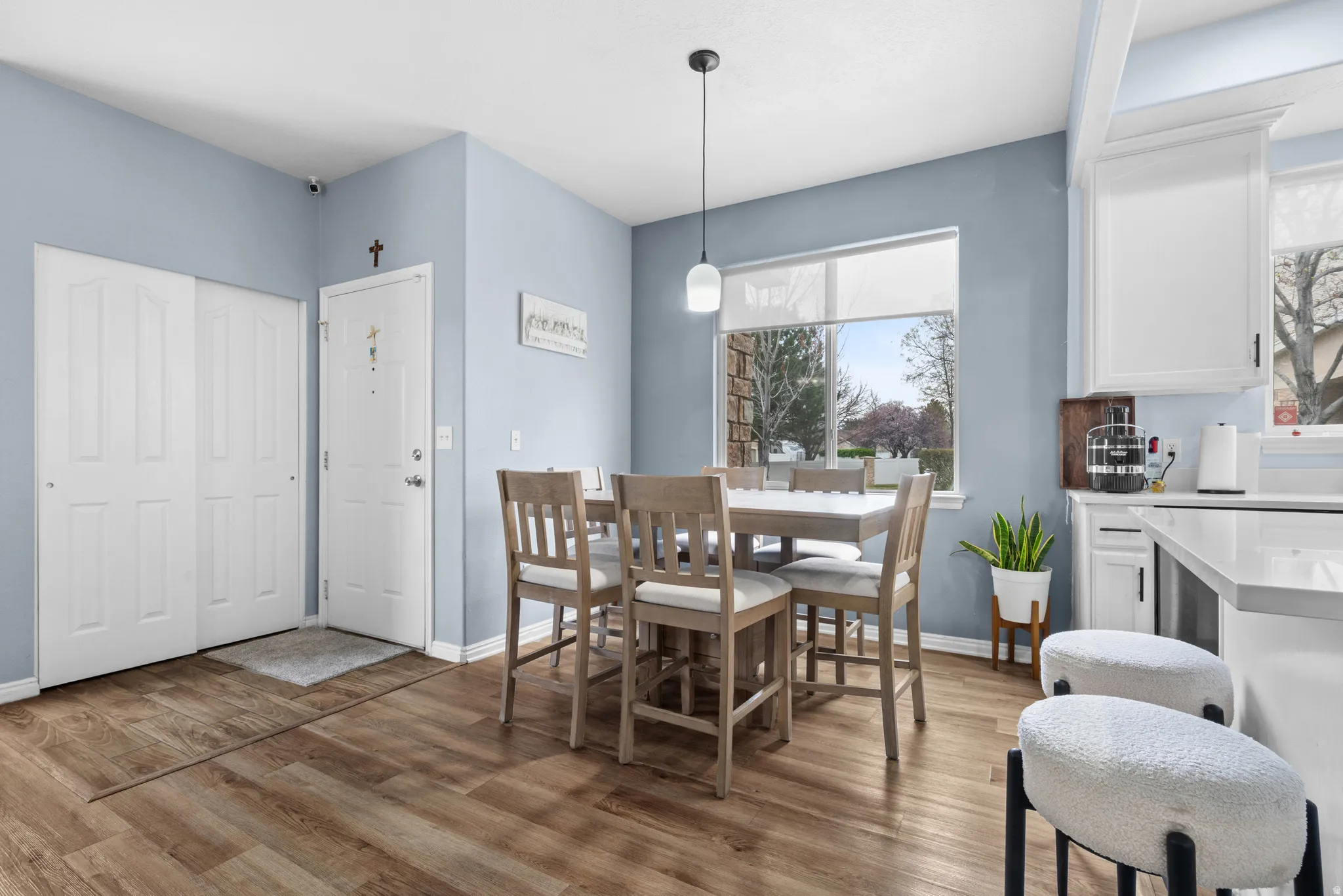 Dining room with light wood-style flooring and baseboards