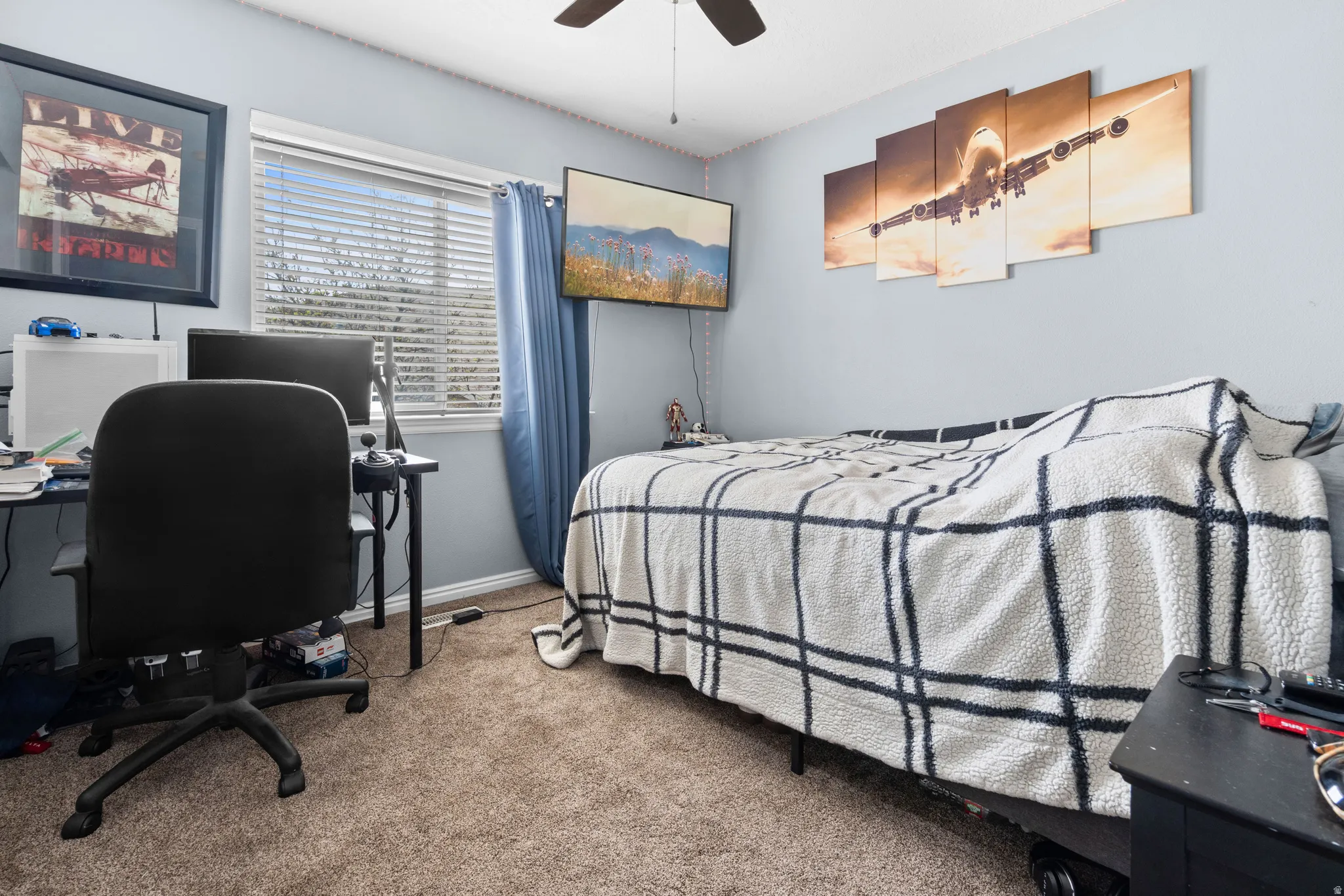 Bedroom with a desk, light carpet, and ceiling fan