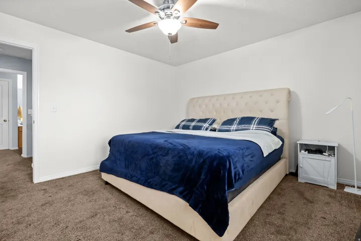 Bedroom with carpet flooring and a ceiling fan
