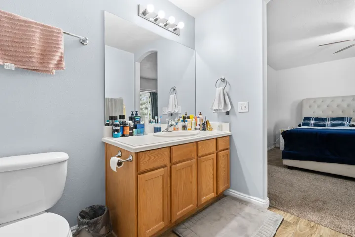 Bathroom with ensuite bathroom, vanity, and light wood finished floors